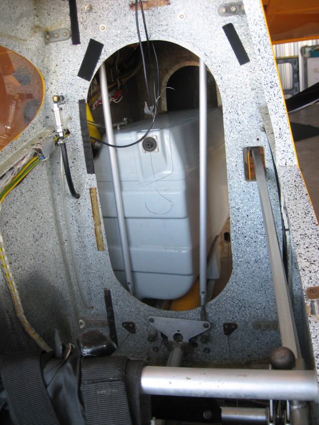 From November, 2011. When I arrived to look at the plane, the owner was just re-installing the fuel tank. The aileron rods are disconnected and the front tank brace is not in yet.