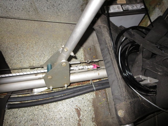 Here, the bungee chord is secured to the eye of the elevator cable where it joins the connecting rod between the two stick controls, underneath the passenger seat.
